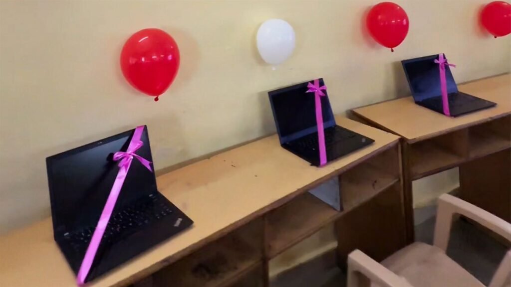 New laptops with ribbons and balloons, ready for the AI lab inauguration at LAKSH Kisannagar
