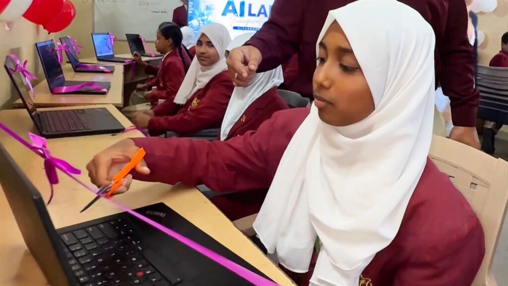 Coding for kids in Karimnagar - a student cuts the ribbon on her laptop at the LAKSH Kisannagar AI lab