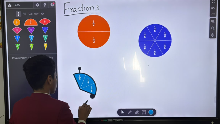 LAKSH student learning fractions on an interactive smart board