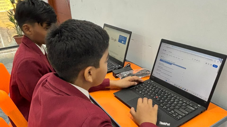 AI learning for students - LAKSH International Schools students researching on laptops in class