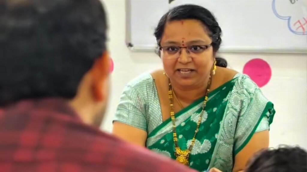 A teacher discusses a student's progress with parents at the LAKSH Razvi Chaman PTM