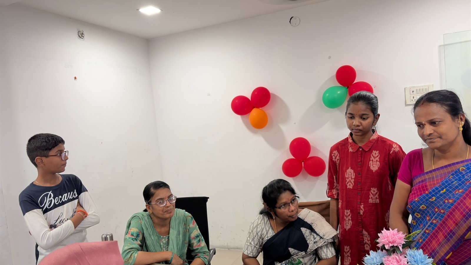 Teachers reviewing a student progress report with parents at PTM 3, LAKSH Kisannagar