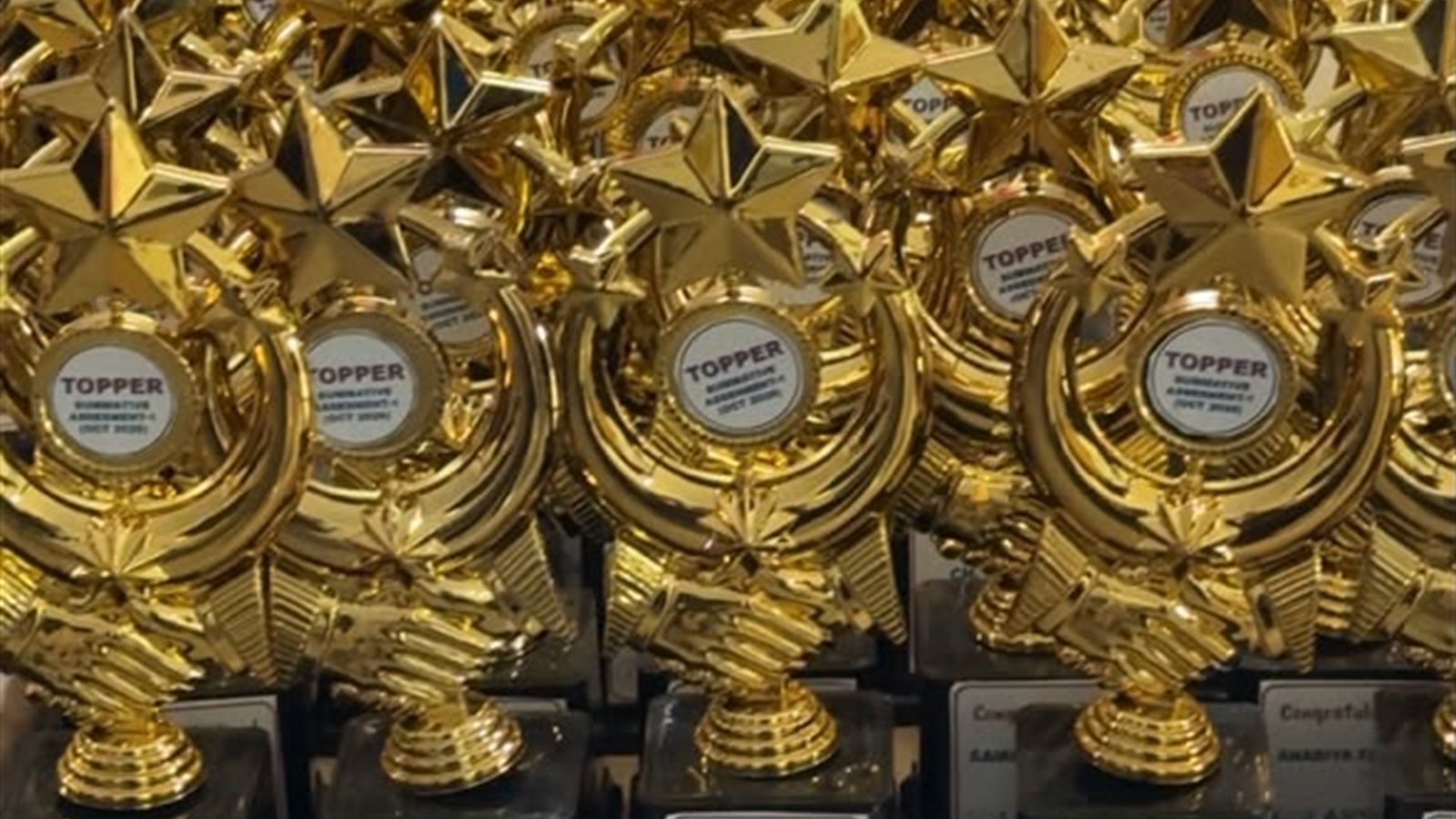 Summative Assessment 1 topper trophies for 60 students at LAKSH Kisannagar, October 2026